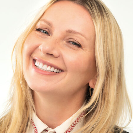 Uśmiechnięta kobieta, Magda, 46 lat – przykład zdrowego uśmiechu po leczeniu ortodontycznym z użyciem nakładek Invisalign®.